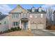Inviting two-story brick home with blue shutters and a two-car garage presents classic curb appeal at 5288 Clingman Ct, Douglasville, GA 30135