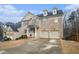 Attractive two-story home boasts a two-car garage and neutral brick exterior with well-maintained landscaping at 5288 Clingman Ct, Douglasville, GA 30135