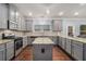 Spacious kitchen with granite countertops, gray cabinetry, stainless appliances, and island at 5288 Clingman Ct, Douglasville, GA 30135