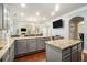 Open-concept kitchen with granite countertops, gray cabinetry, and seamless flow to living area at 5288 Clingman Ct, Douglasville, GA 30135