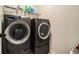 Laundry room with a modern front-loading washer and dryer at 5288 Clingman Ct, Douglasville, GA 30135