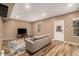 Spacious living room with wood floors, a gray couch, and a door leading to the outside at 5288 Clingman Ct, Douglasville, GA 30135