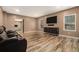Living room with wood floors, a gray couch, and a mounted TV at 5288 Clingman Ct, Douglasville, GA 30135