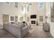 Spacious living room with a fireplace, a large sectional sofa, and tall windows for ample natural light at 5288 Clingman Ct, Douglasville, GA 30135