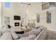 Bright living room features a soaring ceiling, a fireplace, and a comfy sectional sofa with decor at 5288 Clingman Ct, Douglasville, GA 30135