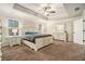 Serene main bedroom suite featuring tray ceilings, neutral carpet, and dual bedside tables at 5288 Clingman Ct, Douglasville, GA 30135