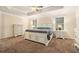 Spacious bedroom with a ceiling fan, tray ceiling, and carpet flooring, creating a relaxing and comfortable retreat at 5288 Clingman Ct, Douglasville, GA 30135