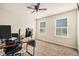 Bright office with neutral carpet, two windows and a ceiling fan at 5288 Clingman Ct, Douglasville, GA 30135