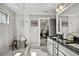 Bathroom featuring granite countertop, double sinks, white subway tile shower with glass door, and window at 5293 Hearthstone St, Stone Mountain, GA 30083