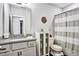 Well-lit bathroom with a granite vanity, storage cabinet, and shower-tub combination at 5293 Hearthstone St, Stone Mountain, GA 30083