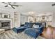 Comfortable living room with a fireplace, hardwood flooring, and a spacious blue sectional sofa at 5293 Hearthstone St, Stone Mountain, GA 30083