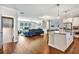 Open living space showcasing kitchen island, fireplace, hardwood floors, and a plush blue sofa at 5293 Hearthstone St, Stone Mountain, GA 30083