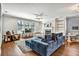 Spacious living area featuring a cozy fireplace and an inviting blue sectional sofa with hardwood floors at 5293 Hearthstone St, Stone Mountain, GA 30083
