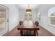 Bright dining area featuring a large wooden table and light fixture with natural light at 5650 Bergeson Way, Cumming, GA 30028