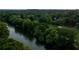 A scenic aerial view of the community bordering the Chattahoochee River, surrounded by lush greenery at 161 Wards Crossing Way # 121, Johns Creek, GA 30022
