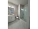 Bathroom with double vanity, white cabinets, and a walk-in shower with glass doors at 161 Wards Crossing Way # 121, Johns Creek, GA 30022