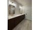 Bathroom features a double sink vanity with dark wood cabinets and a tile floor at 161 Wards Crossing Way # 121, Johns Creek, GA 30022