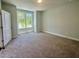 Neutral carpeted bedroom with a window for natural light at 161 Wards Crossing Way # 121, Johns Creek, GA 30022