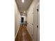 Long hallway with hardwood floors and white doors at 161 Wards Crossing Way # 121, Johns Creek, GA 30022