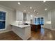 Well-lit kitchen featuring an island, stainless steel appliances, and hardwood floors at 161 Wards Crossing Way # 121, Johns Creek, GA 30022