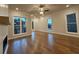 Bright living room with hardwood floors, fireplace, and large windows at 161 Wards Crossing Way # 121, Johns Creek, GA 30022