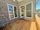 Wooden patio with brick exterior and outdoor access at 161 Wards Crossing Way # 121, Johns Creek, GA 30022