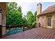 Spacious back deck overlooks a backyard with a pool and plenty of surrounding greenery at 1617 Windsor Ne Pkwy, Brookhaven, GA 30319