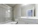 Clean bathroom with white cabinetry, large mirror and glass enclosed shower over tub at 1617 Windsor Ne Pkwy, Brookhaven, GA 30319