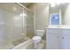 A bright bathroom featuring a glass shower and white cabinets with a sink at 1617 Windsor Ne Pkwy, Brookhaven, GA 30319