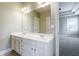 Bathroom with double sink vanity, large mirror and view to bedroom at 1617 Windsor Ne Pkwy, Brookhaven, GA 30319