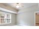 Bedroom features ceiling fan, neutral paint, carpet and plenty of natural light from window at 1617 Windsor Ne Pkwy, Brookhaven, GA 30319