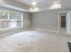 Spacious bedroom boasts tray ceiling, neutral color scheme, carpet and natural light from window at 1617 Windsor Ne Pkwy, Brookhaven, GA 30319