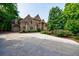 Beautiful multi-story brick home with an attached garage, garden and a circular driveway at 1617 Windsor Ne Pkwy, Brookhaven, GA 30319