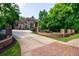 An exterior view of a multi-story brick home with a driveway at 1617 Windsor Ne Pkwy, Brookhaven, GA 30319