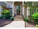 Grand front entrance boasting stone accents, an arched doorway, and a manicured landscape at 1617 Windsor Ne Pkwy, Brookhaven, GA 30319