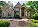 Charming two-story brick home featuring a well-manicured lawn and inviting entrance with arched windows at 1617 Windsor Ne Pkwy, Brookhaven, GA 30319