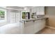 Bright kitchen area has white cabinets, appliances, breakfast bar and views to the outdoor pool at 1617 Windsor Ne Pkwy, Brookhaven, GA 30319