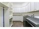 Well-equipped laundry room featuring modern appliances, ample cabinet space, and tile flooring at 1617 Windsor Ne Pkwy, Brookhaven, GA 30319