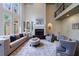 Elegant living room with high ceilings, fireplace, built-in shelving, and comfortable seating arrangement at 1617 Windsor Ne Pkwy, Brookhaven, GA 30319