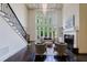 Bright living room featuring a fireplace, large windows, and a staircase at 1617 Windsor Ne Pkwy, Brookhaven, GA 30319