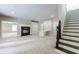 Large living room with fireplace, custom storage, and staircase at 1617 Windsor Ne Pkwy, Brookhaven, GA 30319