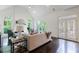 Bright living room with vaulted ceilings, stone fireplace, and large windows overlooking lush greenery at 1617 Windsor Ne Pkwy, Brookhaven, GA 30319