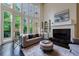 Spacious living room with a fireplace, built-in shelving, and soaring windows offering natural light at 1617 Windsor Ne Pkwy, Brookhaven, GA 30319