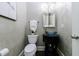 Elegant powder room featuring stylish vanity with vessel sink, decorative mirror, and chandelier lighting at 1617 Windsor Ne Pkwy, Brookhaven, GA 30319