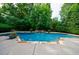 Backyard swimming pool featuring stone accents, lush greenery, and a tranquil atmosphere for relaxation at 1617 Windsor Ne Pkwy, Brookhaven, GA 30319