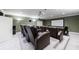 Cozy theater room features tiered seating with plush leather recliners, projector and screen for entertainment at 1617 Windsor Ne Pkwy, Brookhaven, GA 30319