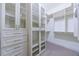 Large walk-in closet featuring built-in shelving, cabinets, and drawers for storage solutions at 1617 Windsor Ne Pkwy, Brookhaven, GA 30319