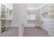A spacious walk-in closet with built-in shelving, cabinets, and drawers for ample storage at 1617 Windsor Ne Pkwy, Brookhaven, GA 30319