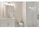 Well-lit bathroom with white vanity, stone counter, and glass-enclosed shower at 169 Wards Crossing Way # 125, Johns Creek, GA 30022