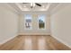 This bedroom boasts a tray ceiling with recessed lighting, crown molding, and hardwood flooring at 169 Wards Crossing Way # 125, Johns Creek, GA 30022